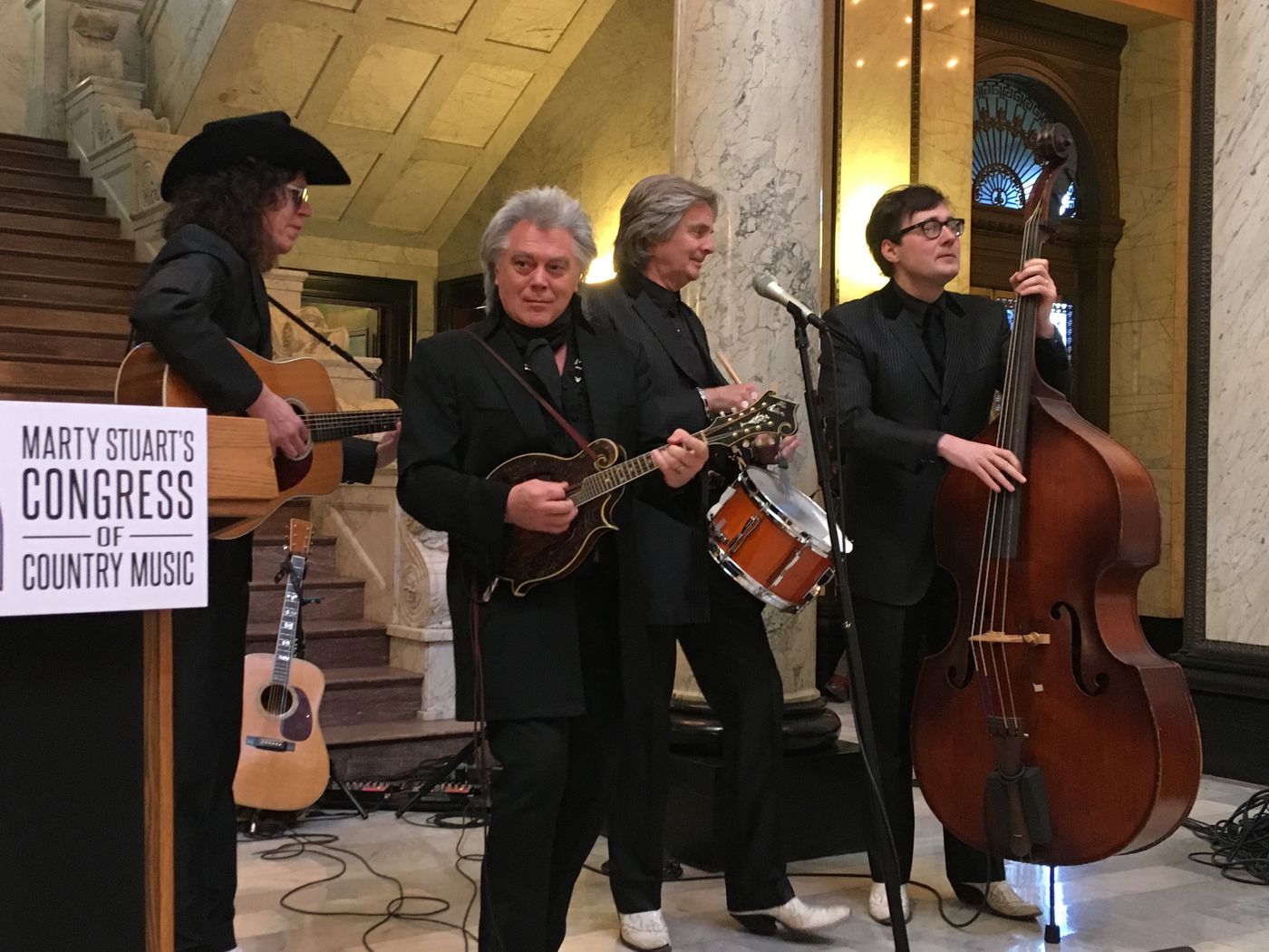 Country singer Marty Stuart, second from left, performs at the Mississippi Capitol with members of his band, The Fabulous Superlatives, on Wednesday, Jan. 31, 2018. Band members are Kenny Vaughan, left, Harry Stinson, second from right, and Chris Scruggs. Stuart says he is planning to develop a museum called Marty Stuart's Congress of Country Music in his hometown of Philadelphia, Miss. ( AP Photo/Emily Wagster Pettus)