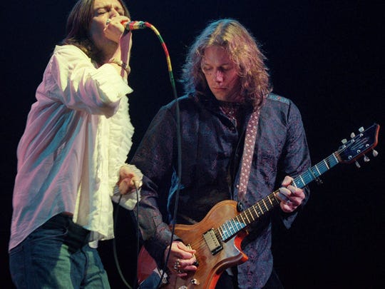 The Black Crowes, featuring Chris Robinson, left, and his brother, Rich Robinson, perform at New York's Radio City Music Hall in 2001.