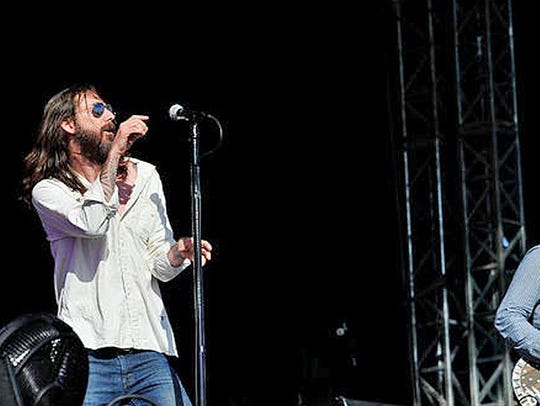 Chris Robinson, left, and Rich Robinson of the Black Crowes perform in 2013 in London.