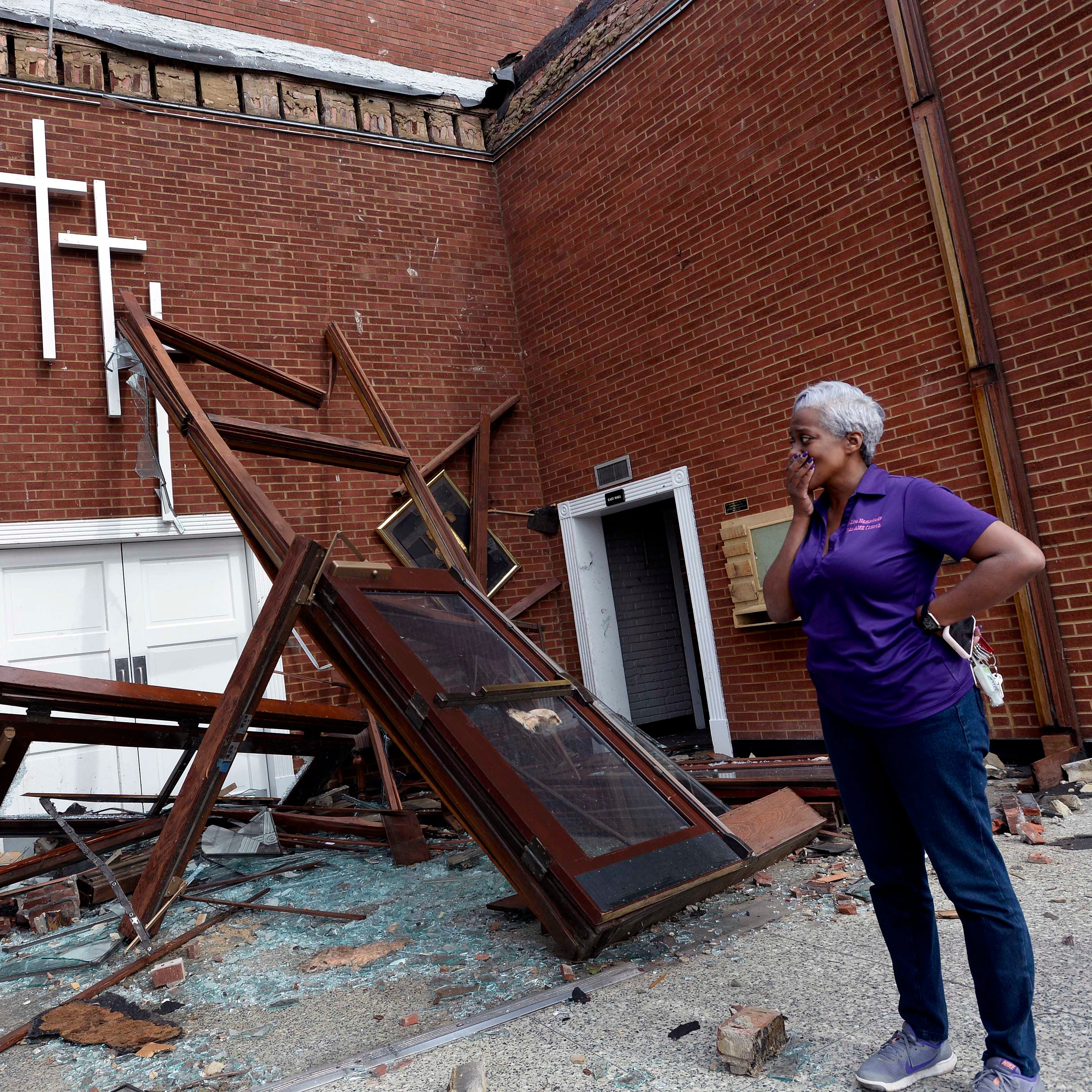 The Rev. Lisa Hammonds of the St. John A.M.E. Church fights back her emotions as she looks over the tornado damage to her church on Wednesday, March 4, 2020, in North Nashville, Tenn.