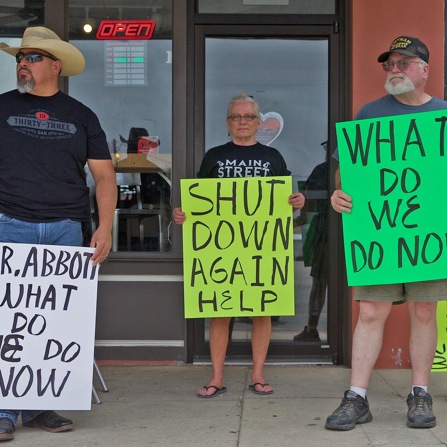 Demonstrators protest in downtown San Angelo on Saturday, June 27, 2020 against the governor's order to close bars again due to rising positive cases of the coronavirus.