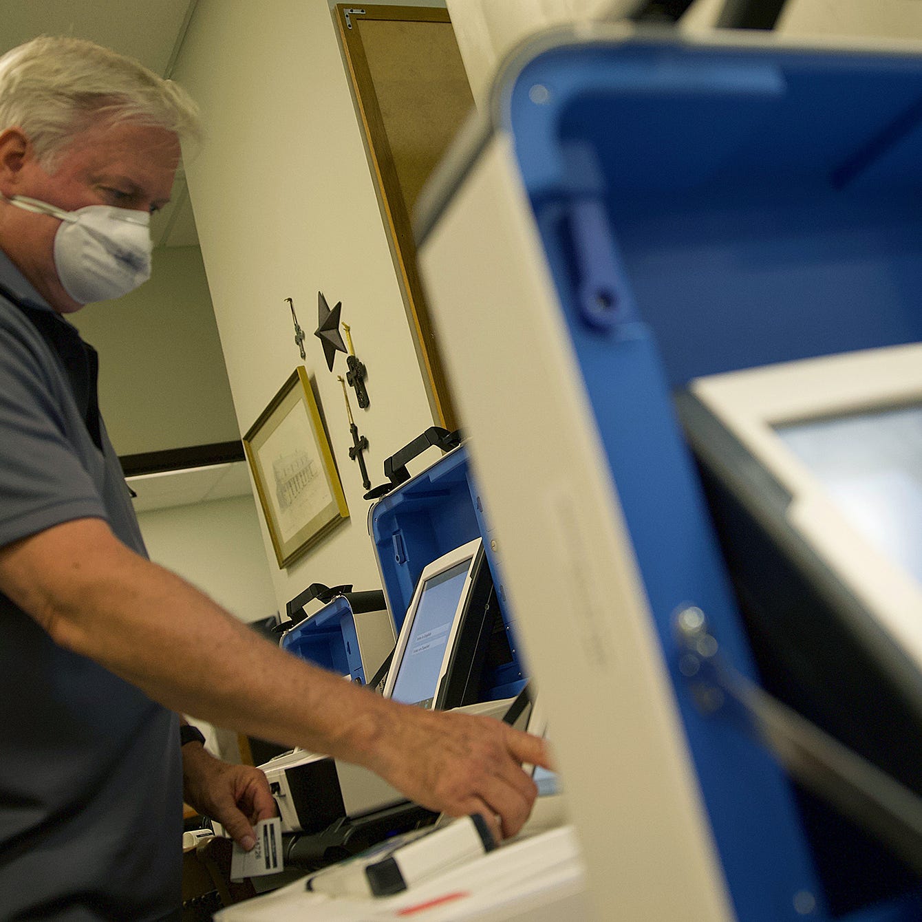 Johnny Fisher works with voting machines at the Tom Green County election office on Wednesday, June 24, 2020.