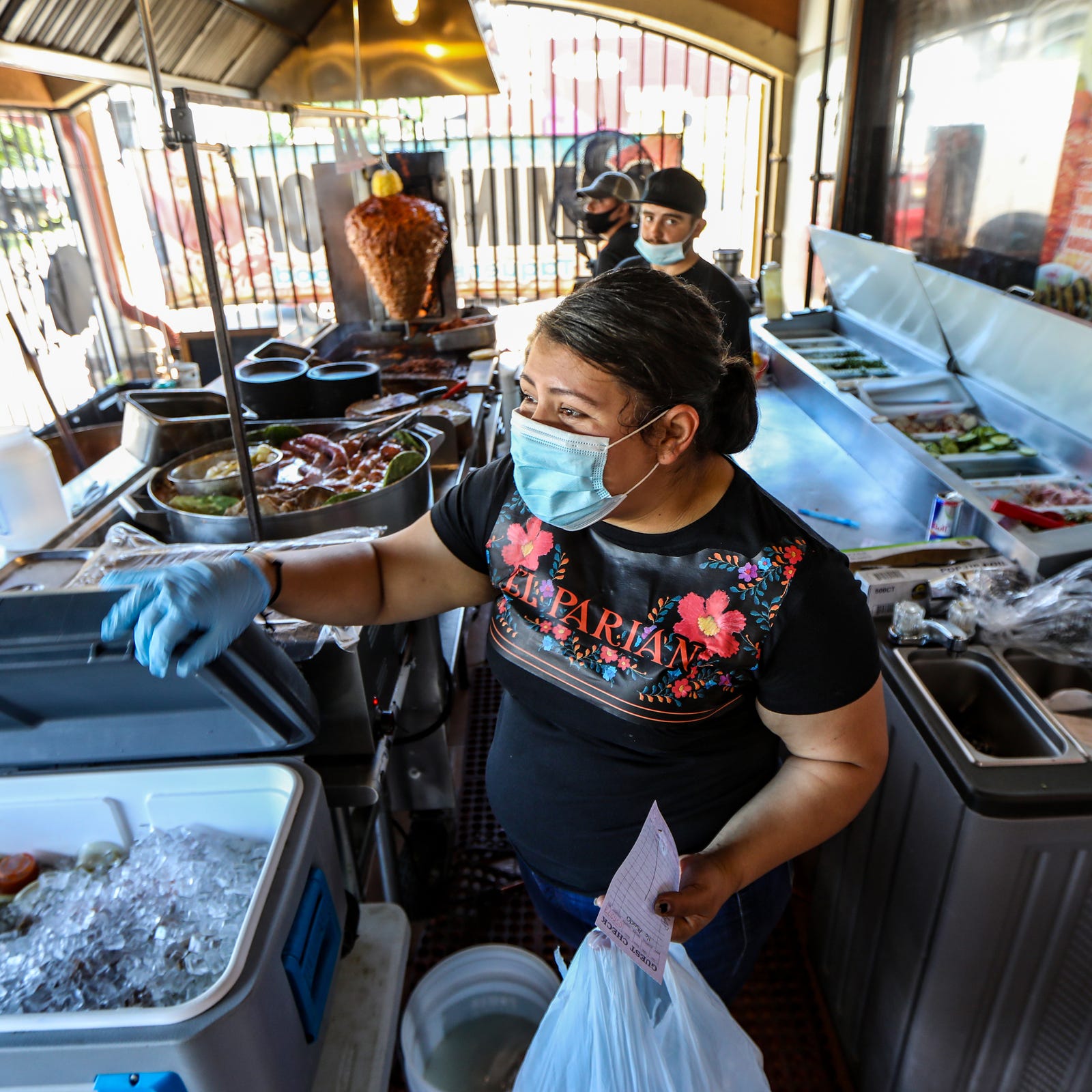 Co-owner Nancy Diaz prepares and hands over a to-go order at La Palapa del Parian Mexican restaurant in southwest Detroit, photographed on Friday, July 24, 2020. Diaz says the restaurant serves a mix between street food and authentic cuisine from Jalisco, Mexico. 