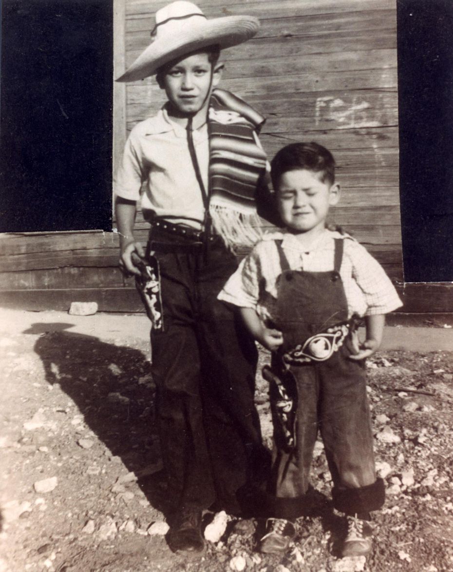Trini Lopez, left, 11, and his brother Jesse Lopez, 5, pose for a photo in their western wear in Dallas' Little Mexico. 