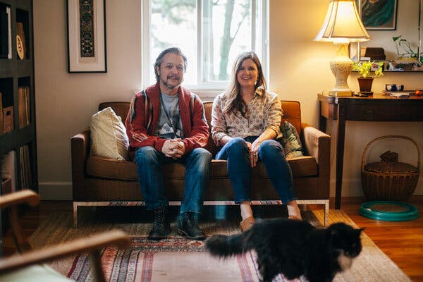 Lance and April Ledbetter and their cat, Louie, at home in Atlanta.